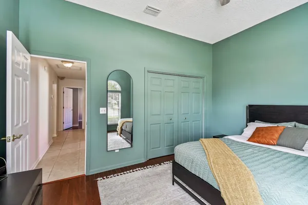 a bedroom with a large bed and a window