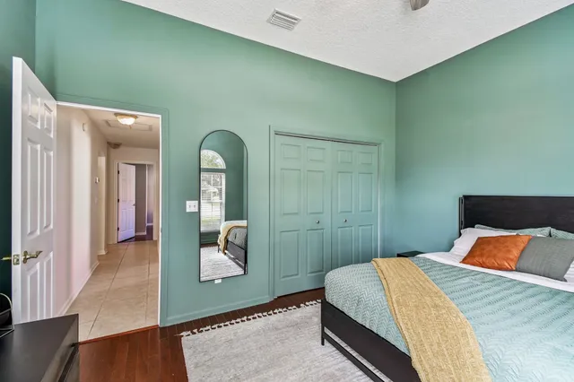 a bedroom with a large bed and a window