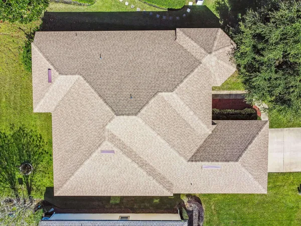 an aerial view of residential houses with outdoor space