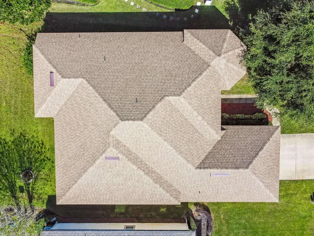 an aerial view of residential houses with outdoor space