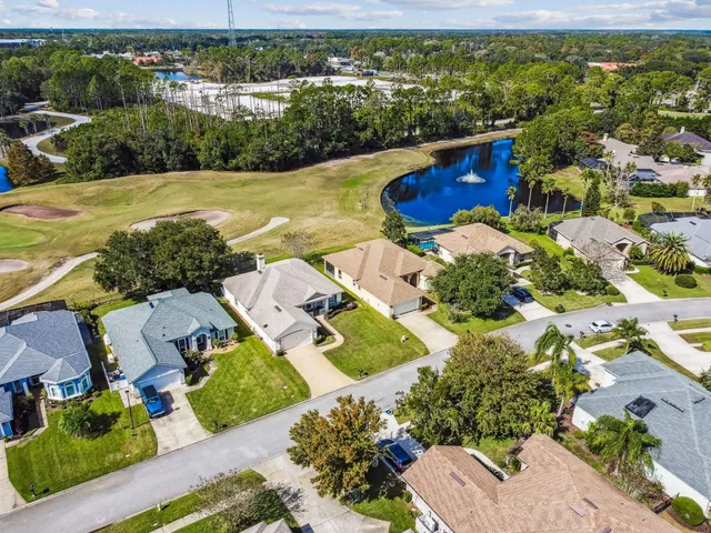 a view of a water fountain with potted plants in front of it