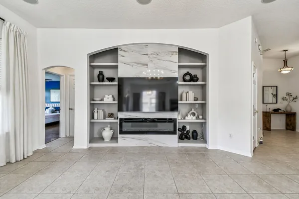 a living room with furniture and a chandelier