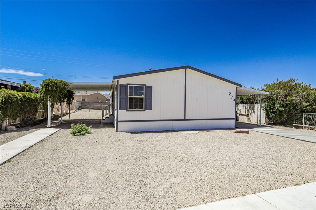 273 Aztec Lane Henderson, NV 89015 - Photo 1 of 28 A well-maintained manufactured home with a spacious gravel lot and a practical covered carport awaits.