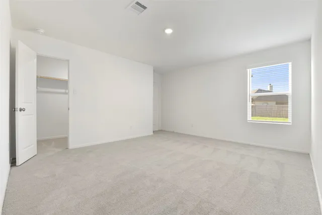 an empty room with windows and closet