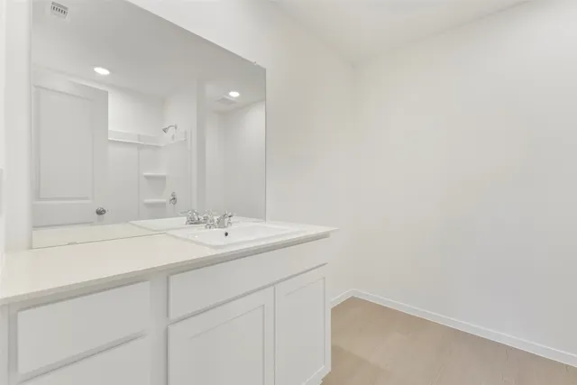 a bathroom with a sink a vanity and a mirror