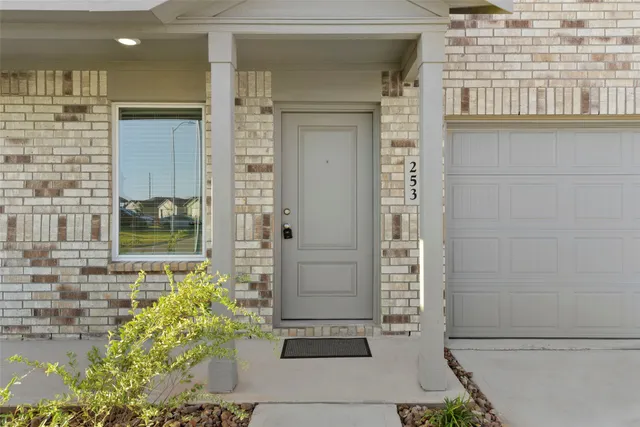 a view of front door of house and a yard