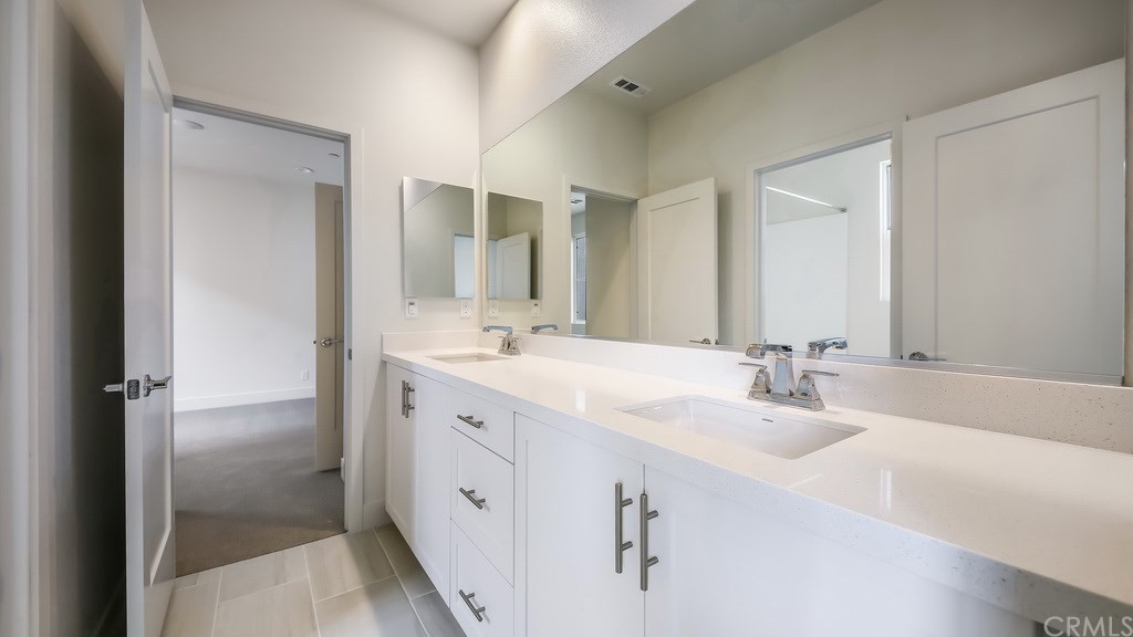 131 Novel Irvine, CA 92618 - Photo 11 of 15 a bathroom with double vanity sinks and a mirror