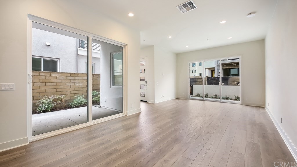 131 Novel Irvine, CA 92618 - Photo 4 of 15 a view of a big room with wooden floor and door