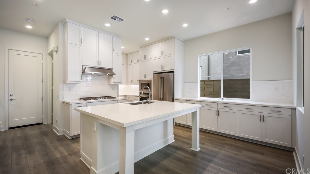 131 Novel Irvine, CA 92618 - Photo 5 of 15 a kitchen with a stove a sink and a refrigerator