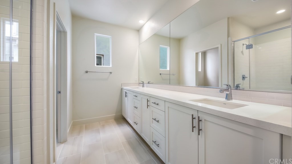 131 Novel Irvine, CA 92618 - Photo 9 of 15 a spacious bathroom with a double vanity sink and mirror