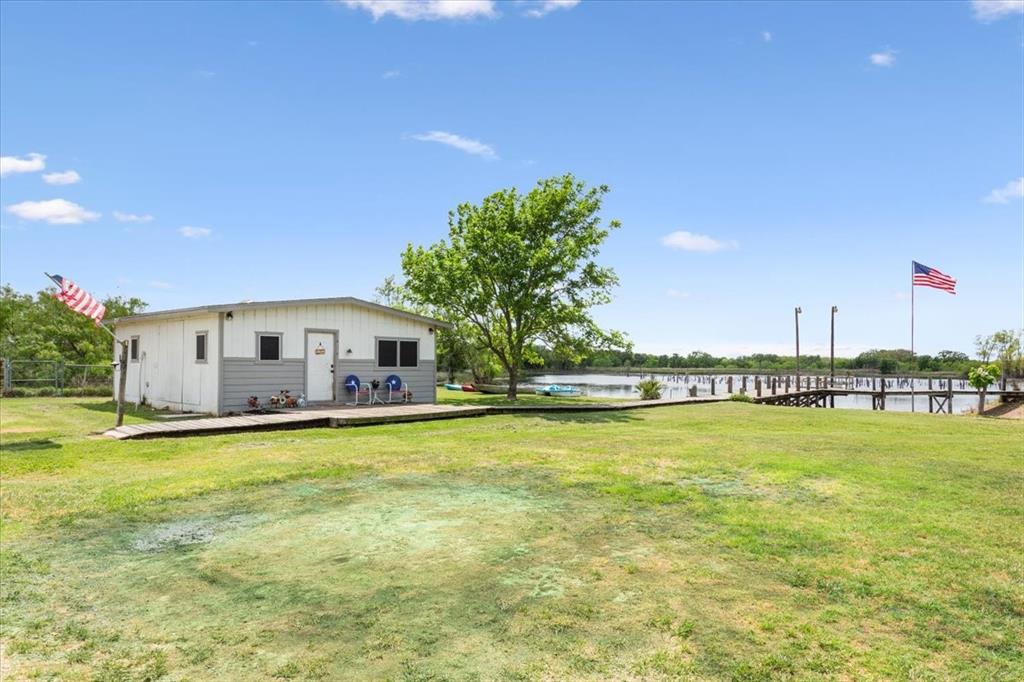 3356 Kattner Road Riesel, TX 76682 - Photo 33 of 40 View of yard featuring a deck with water view and fence