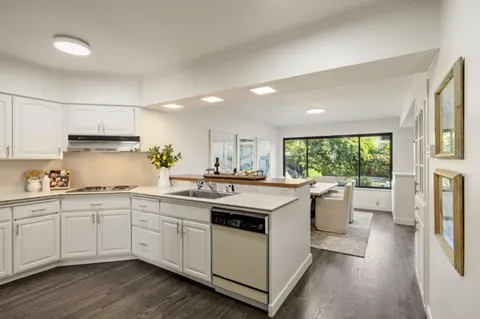 a kitchen with a sink stove and cabinets