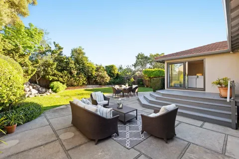 a view of swimming pool with outdoor seating and plants