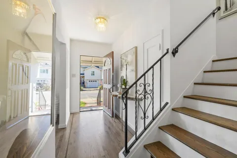 a view of staircase with wooden floor and floors