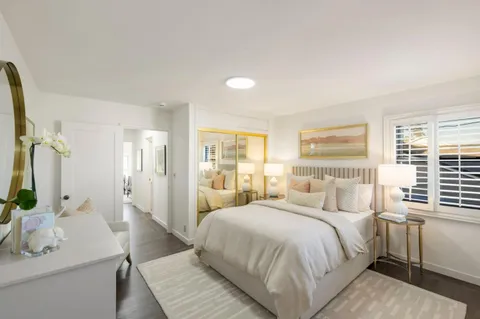 a bedroom with a large bed and a large window