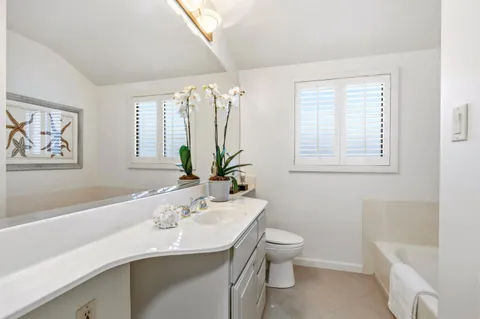 a bathroom with a sink toilet and a mirror