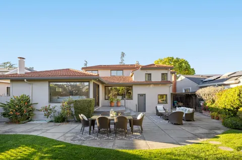 a view of a house with backyard porch and sitting area
