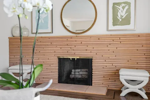 a front view of a house with wooden floor and a potted plant