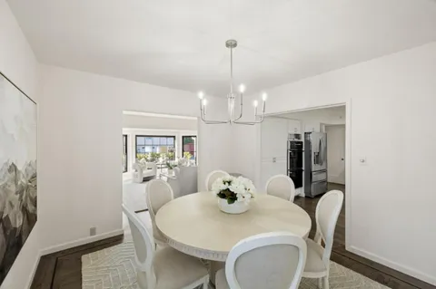a view of a dining room with furniture and chandelier