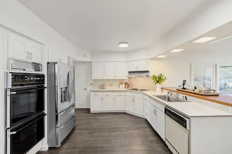 a kitchen with a sink stove and refrigerator