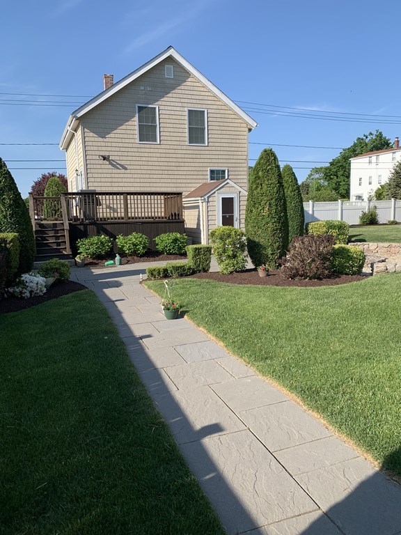 398 Chicago Street Fall River, MA 02721 - Photo 19 of 26 a view of a white house with a big yard and potted plants
