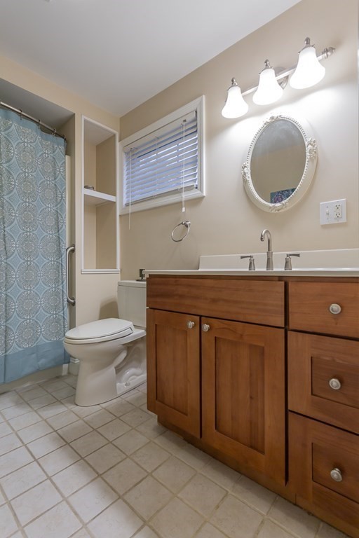 398 Chicago Street Fall River, MA 02721 - Photo 8 of 26 a bathroom with a toilet a sink and mirror