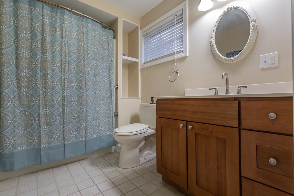 398 Chicago Street Fall River, MA 02721 - Photo 9 of 26 a bathroom with a sink a toilet and a mirror