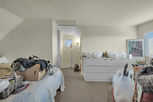 a living room with furniture and a mirror