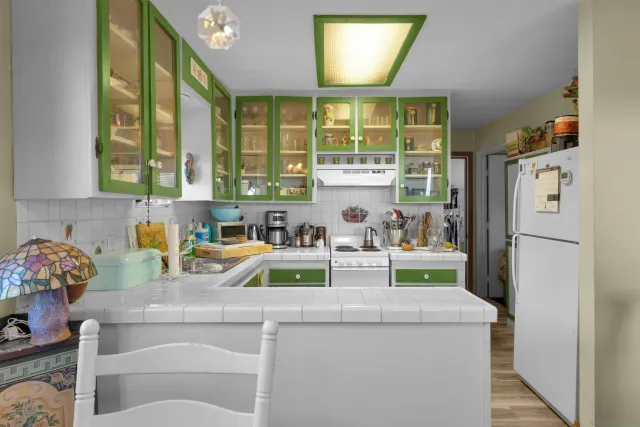 a view of kitchen with refrigerator and window