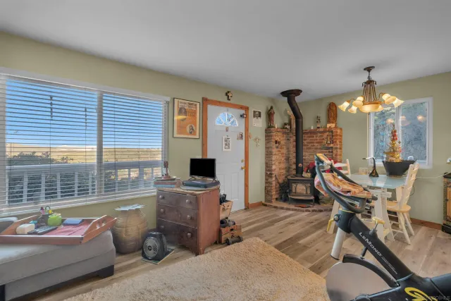 a view of a livingroom with furniture and a large window