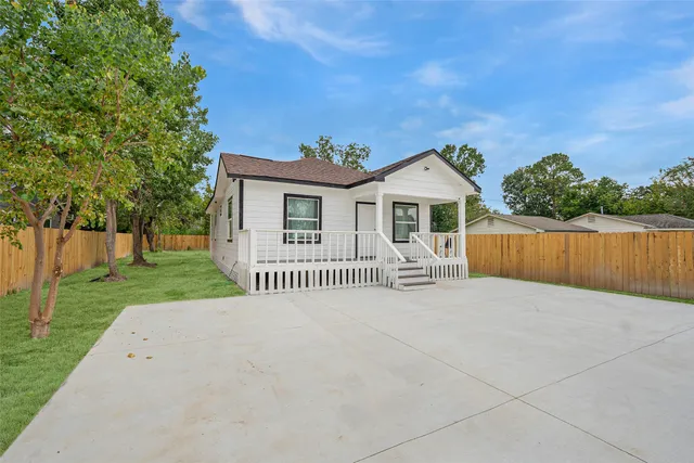 a front view of a house with a garden and yard
