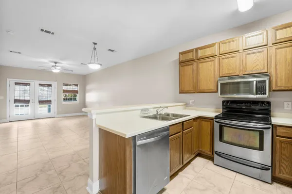 a kitchen with stainless steel appliances granite countertop a stove and a sink