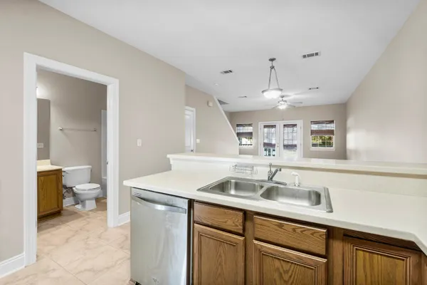 a kitchen with a sink a toilet and cabinets