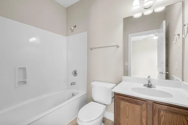 a bathroom with a sink toilet vanity and shower