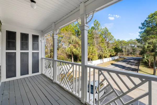 a view of balcony with wooden floor and fence