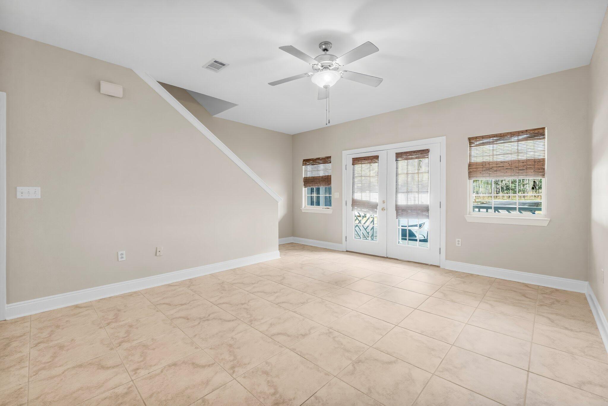 254 South Co Highway 393, Unit 2 Santa Rosa Beach, FL 32459 - Photo 6 of 45 an empty room with windows and chandelier fan