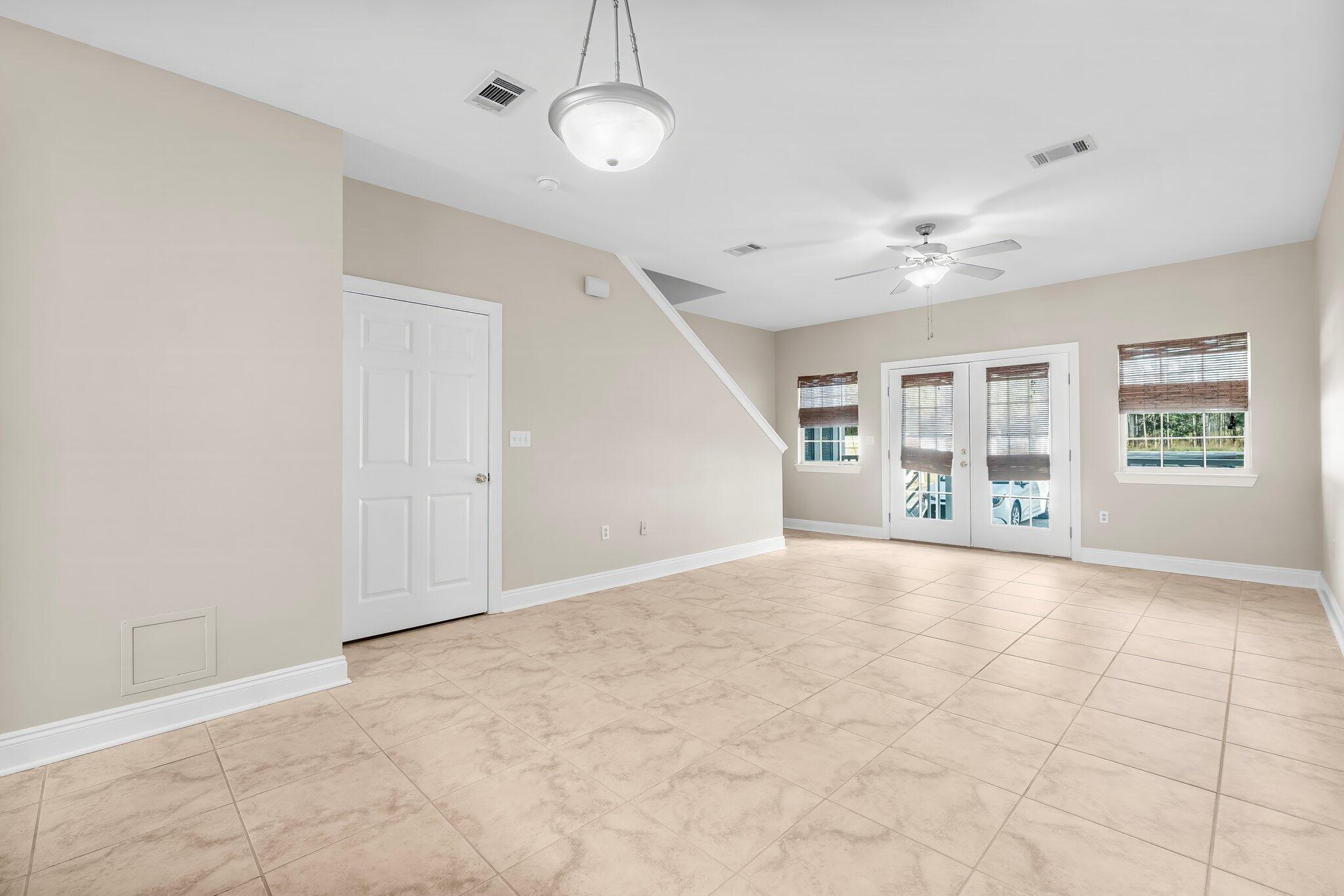 254 South Co Highway 393, Unit 2 Santa Rosa Beach, FL 32459 - Photo 9 of 45 an empty room with chandelier fan and windows