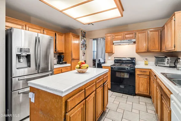 a kitchen with stainless steel appliances a refrigerator sink and stove