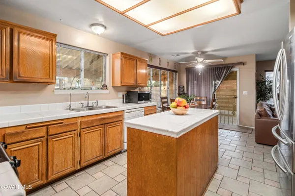 a kitchen with stainless steel appliances kitchen island a sink stove and cabinets