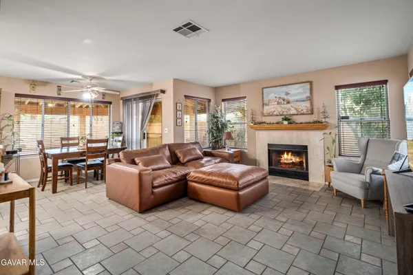 a living room with furniture large window and a fireplace