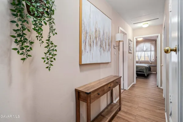 a view of a hallway with wooden floor and staircase