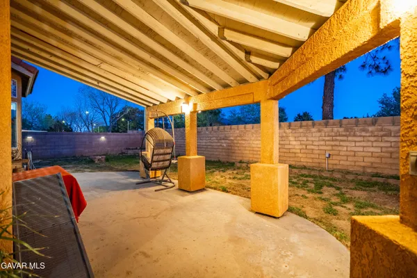 a backyard of a house with barbeque oven table and chairs