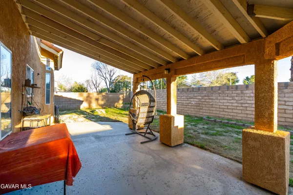 a view of a porch with furniture and a backyard