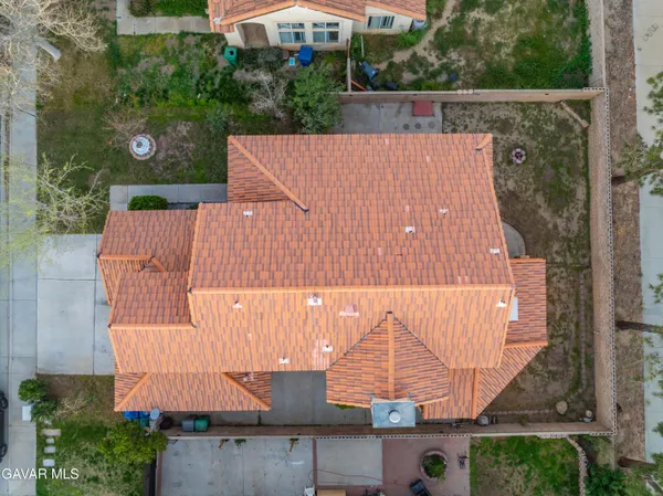 an aerial view of a house with a yard