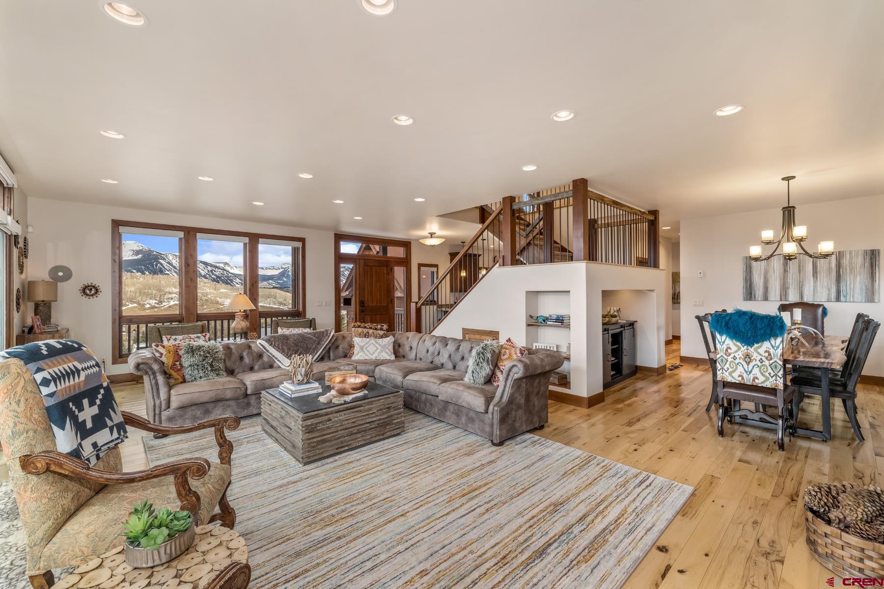 32 Cinnamon Mountain Road Crested Butte, CO 81225 - Photo 7 of 44 a living room with furniture kitchen view and a wooden floor