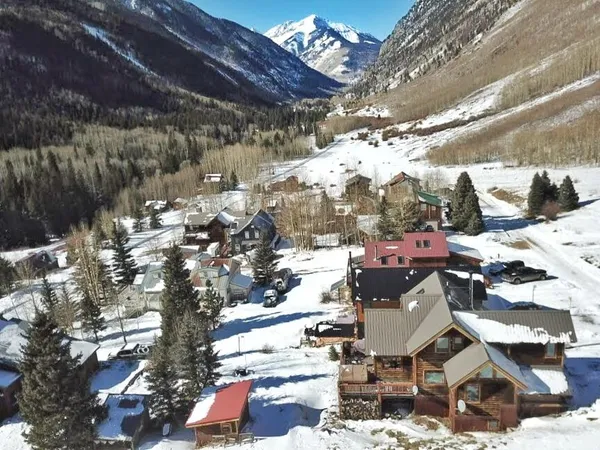 a front view of a house with yard and parking