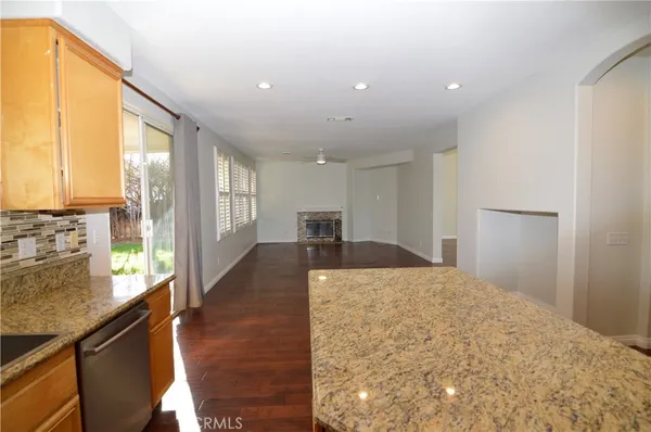 a large white kitchen with kitchen island a large window in it
