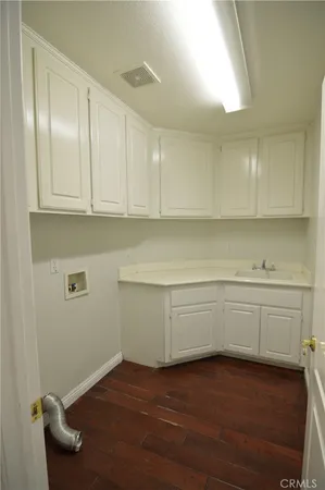 a view of cabinets and wooden floor