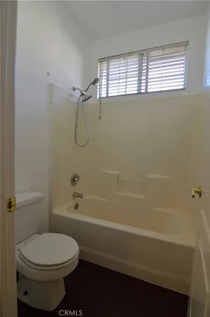 a bathroom with a toilet a sink and shower