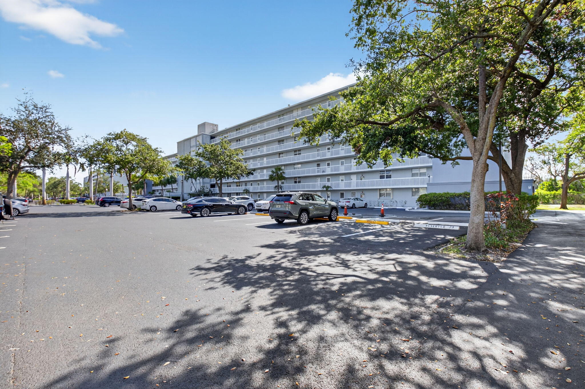 5500 Northwest 2nd Avenue, Unit 718 Boca Raton, FL 33487 - Photo 1 of 34 a view of road with large trees